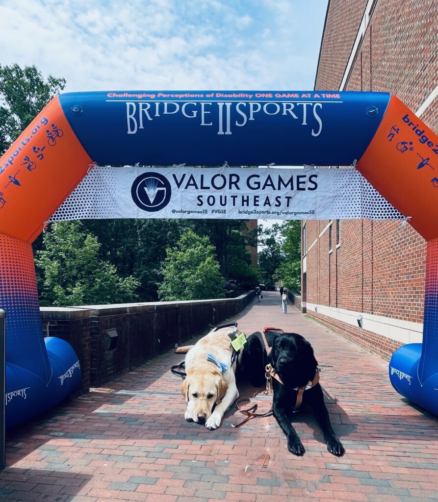 Donald (left) and Tavi (right) lie together under the Valor Games inflatable arch.