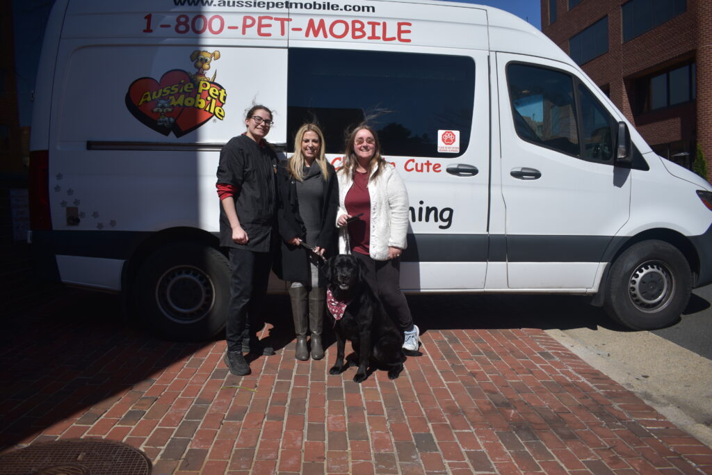 Left to right with guide dog Shadow following a relaxing facial, Yasmin Vosburg of Aussie Pet Mobile, Meredith Buono-DaGrossa, and Kathy Ferro