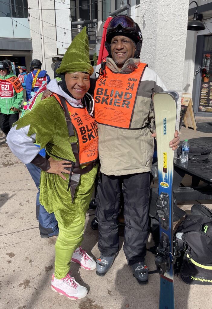 Michaun Harrison (left) and Harvey Guary wearing neon orange blind skier vests.