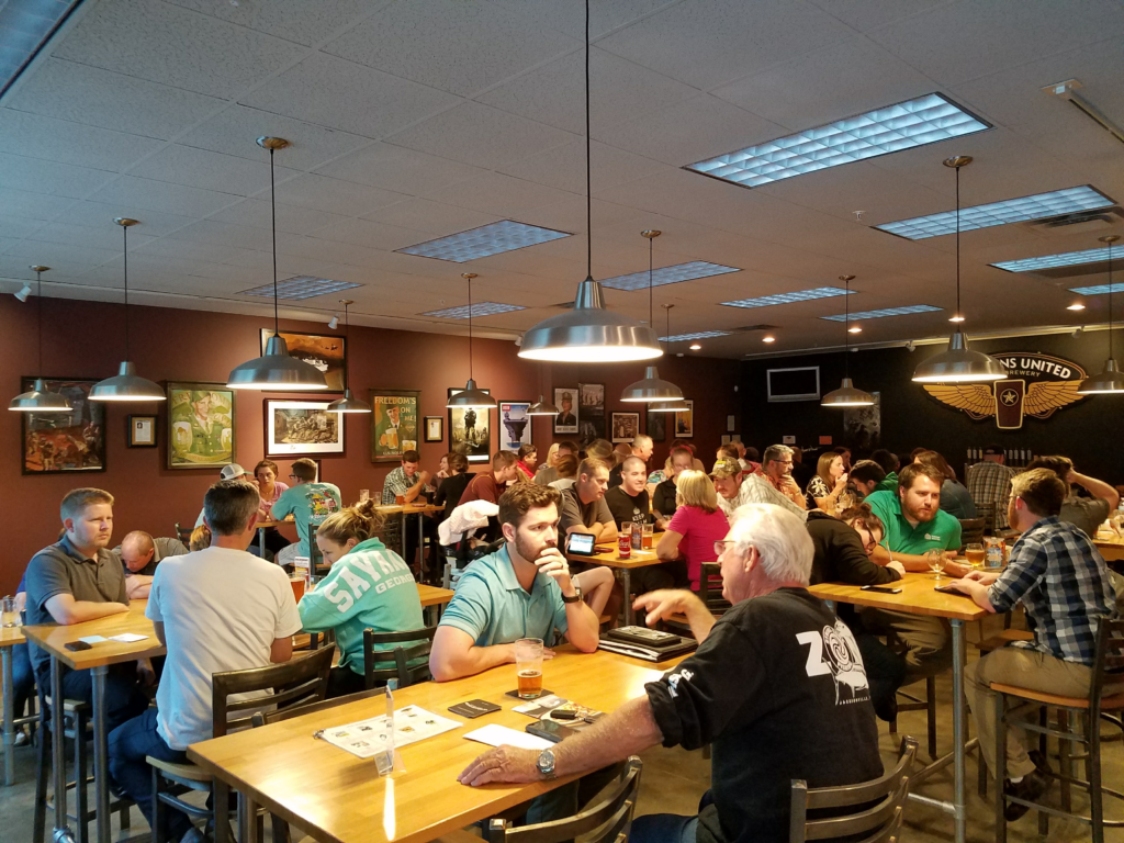 People occupying tables at Veterans United Craft Brewery.