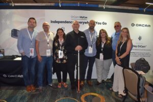 BVA members and OrCam Representatives pose for a group picture in front of the OrCam Exhibitor Booth at the BVA National Convention