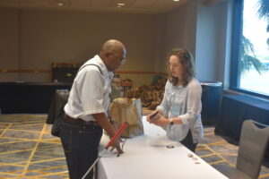 WayAround's Jessica Hipps helps another BVA member with registration at BVA National Convention