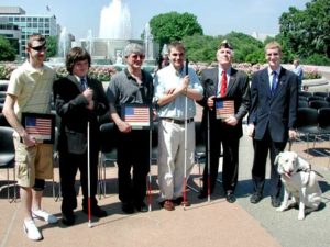 6 Members in front of a Fountain, along with a seeing eye dog.